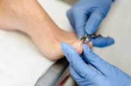 Young woman cutting toenail, close-up